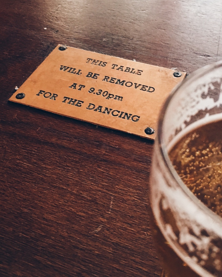 A table at Hootenanny's with a plaque in the centre saying 'This table will be removed at 9.30pm for the dancing'